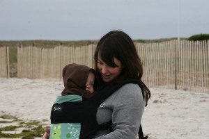 Wearing my sleepy 15 month old on the beach. 